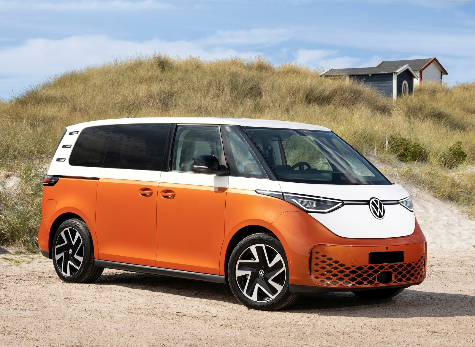 orange volkswagen id buzz import on a beach